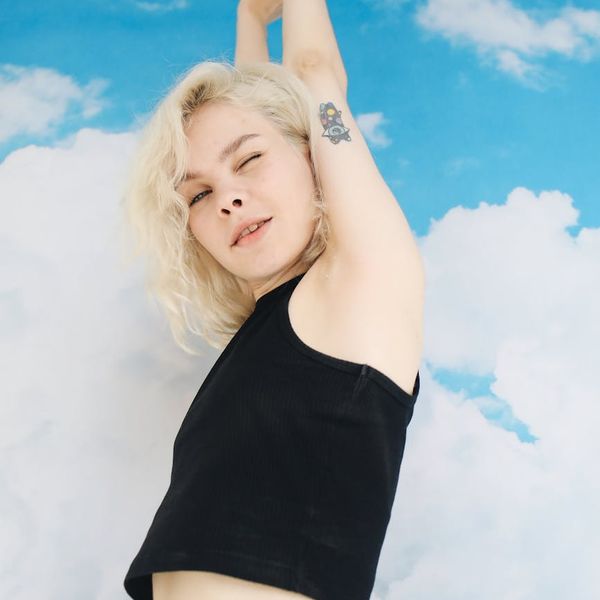 Smiling woman stretching outdoors, feeling energetic and free.
