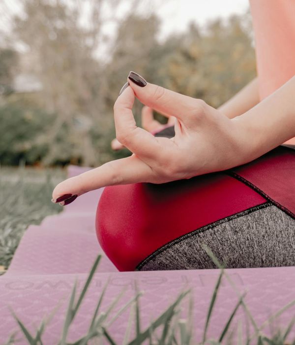 Woman in a calm yoga pose, embodying peace and balance.